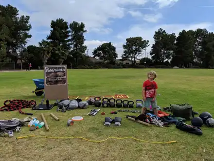 Adults and children at an outdoor Pesky Blubber workout — M329